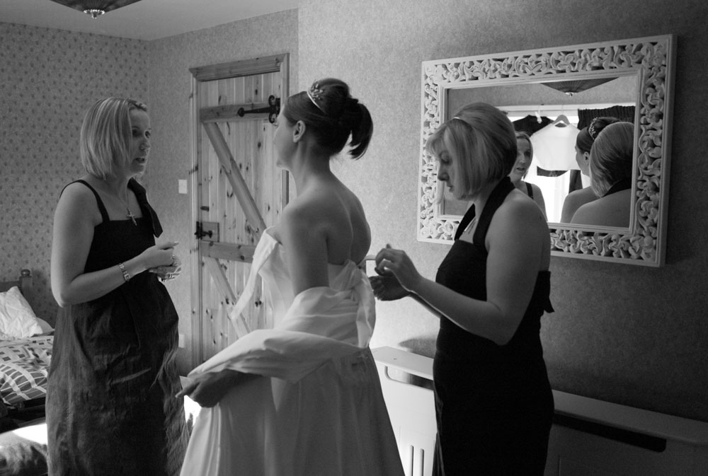 The bride chats with her bridesmaids at Simonstone Hall Hotel