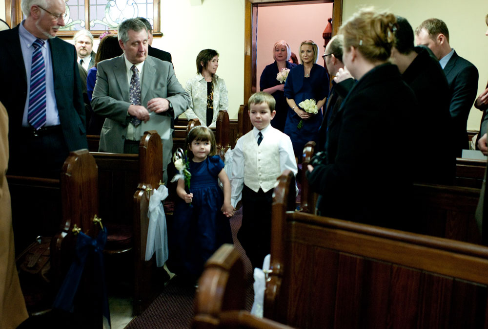 Little bridesmaid and pageboy lead the procession at Simonstone Hall Hotel