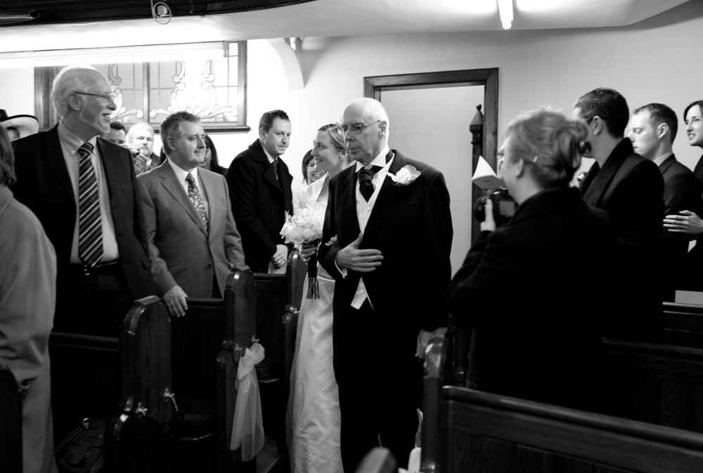 The bride and her father walk down the aisle