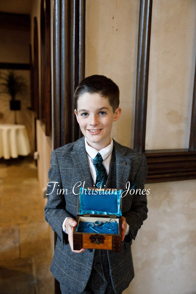 Candid moment of pageboy carrying wedding rings.