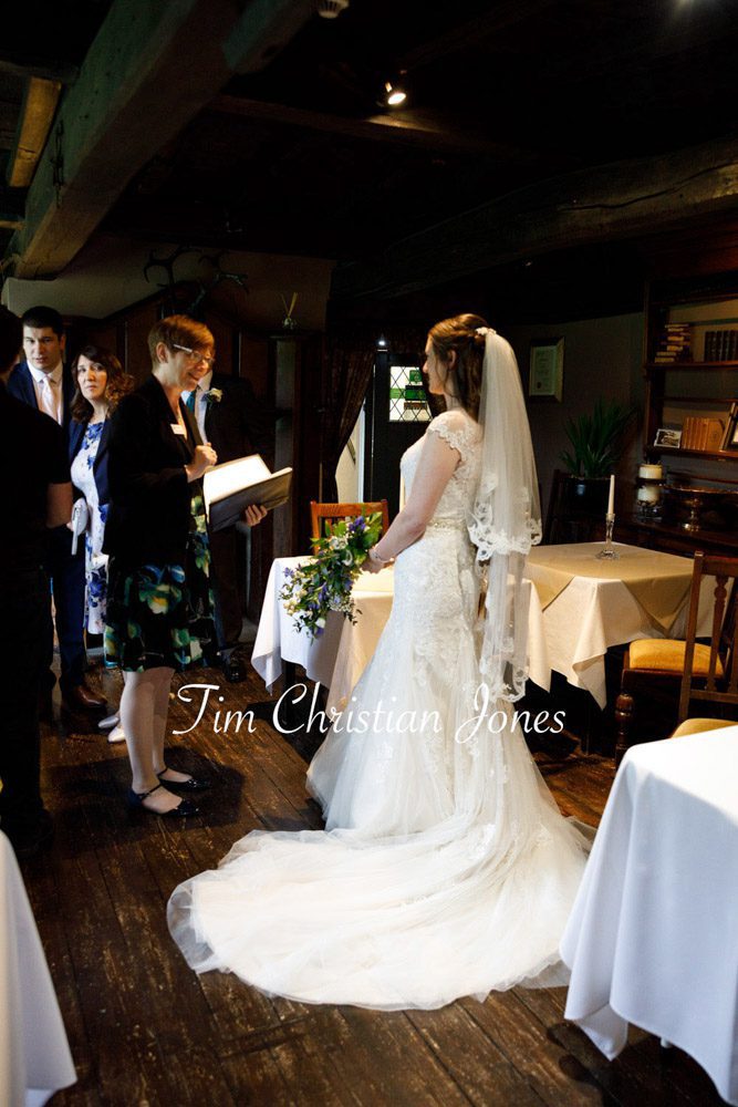 Natural wedding photography of bride with registrar at The Priests House