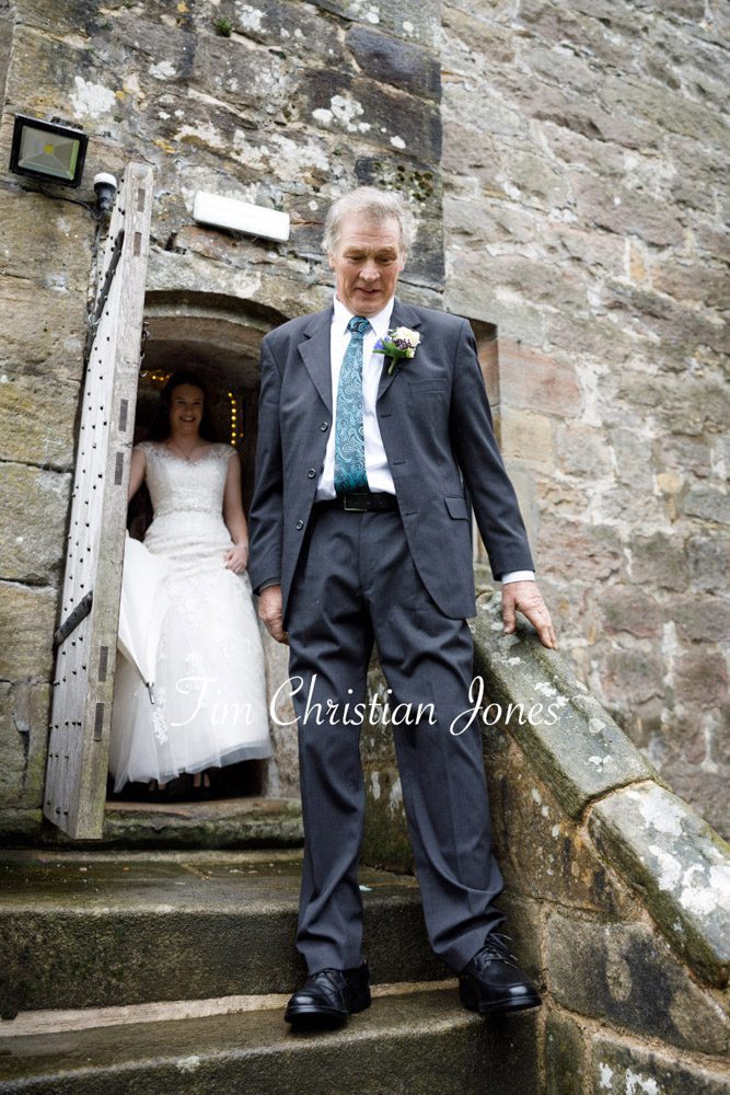 Father of the bride walking down stone steps at The Priests House, Barden Tower.