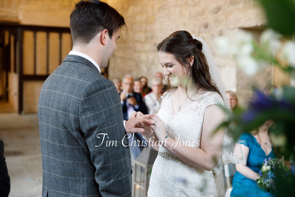 Romantic Yorkshire wedding moment as couple exchange rings.