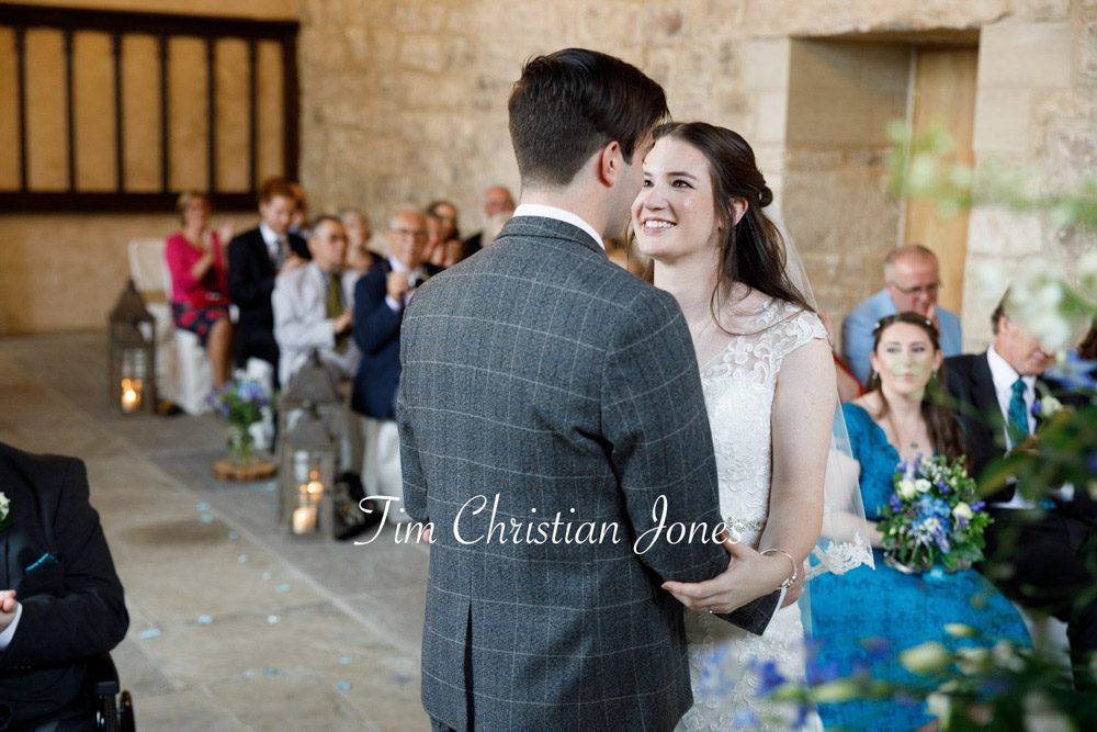 Loving glance between bride and groom during ceremony.