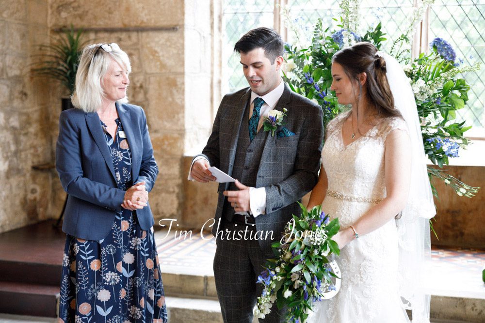 Couple receiving the wedding register during their romantic Yorkshire wedding ceremony.