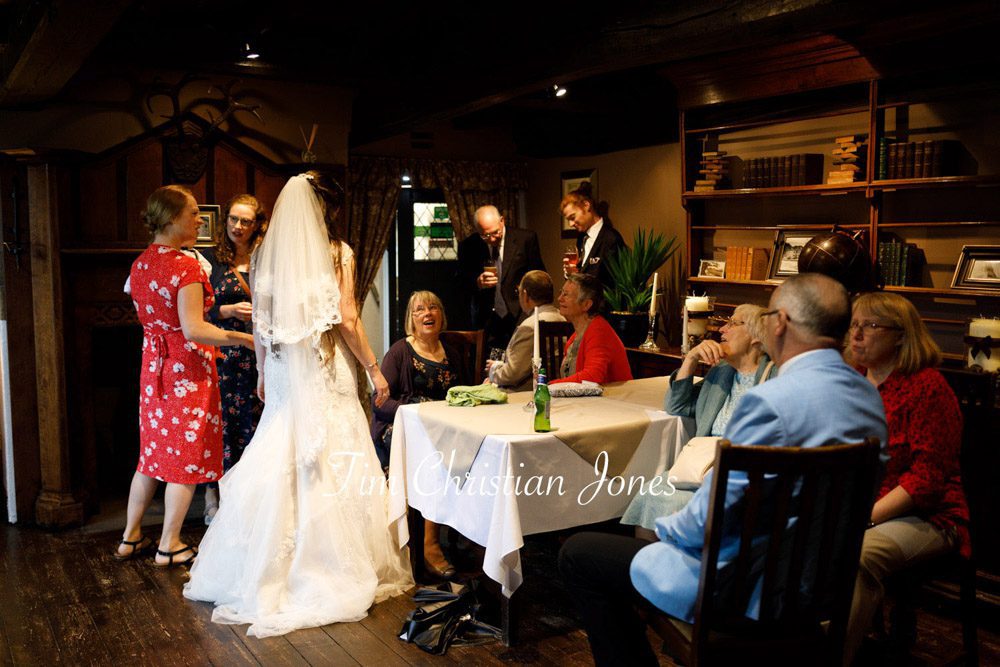 Natural candid of guests and bride staying dry at Barden Tower wedding
