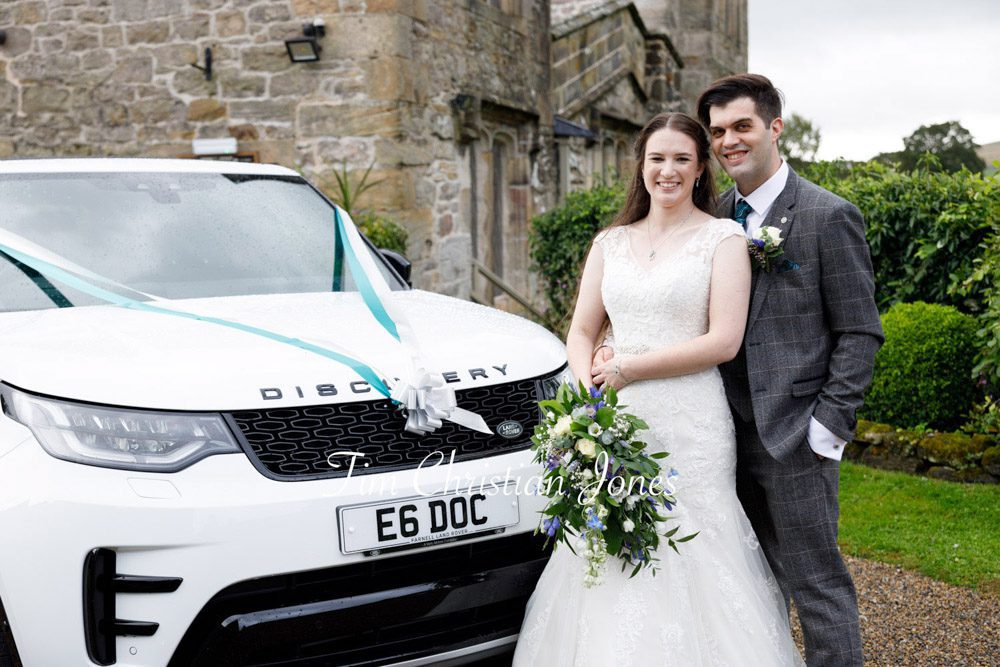 Couple stood proudly by their wedding car at The Priests House.