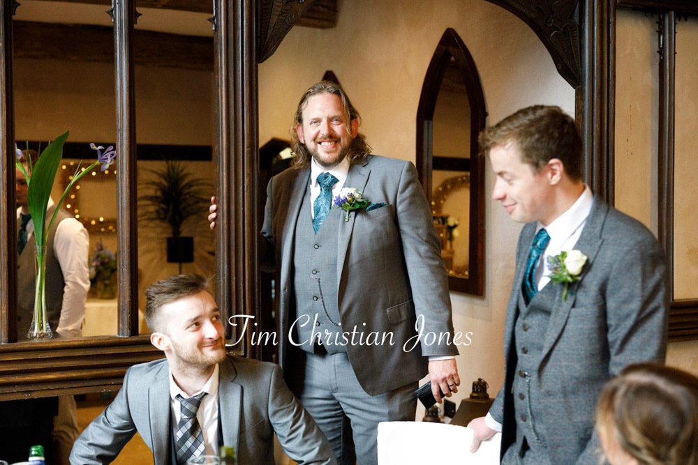 Candid photo of the best man smiling at The Priests House wedding.
