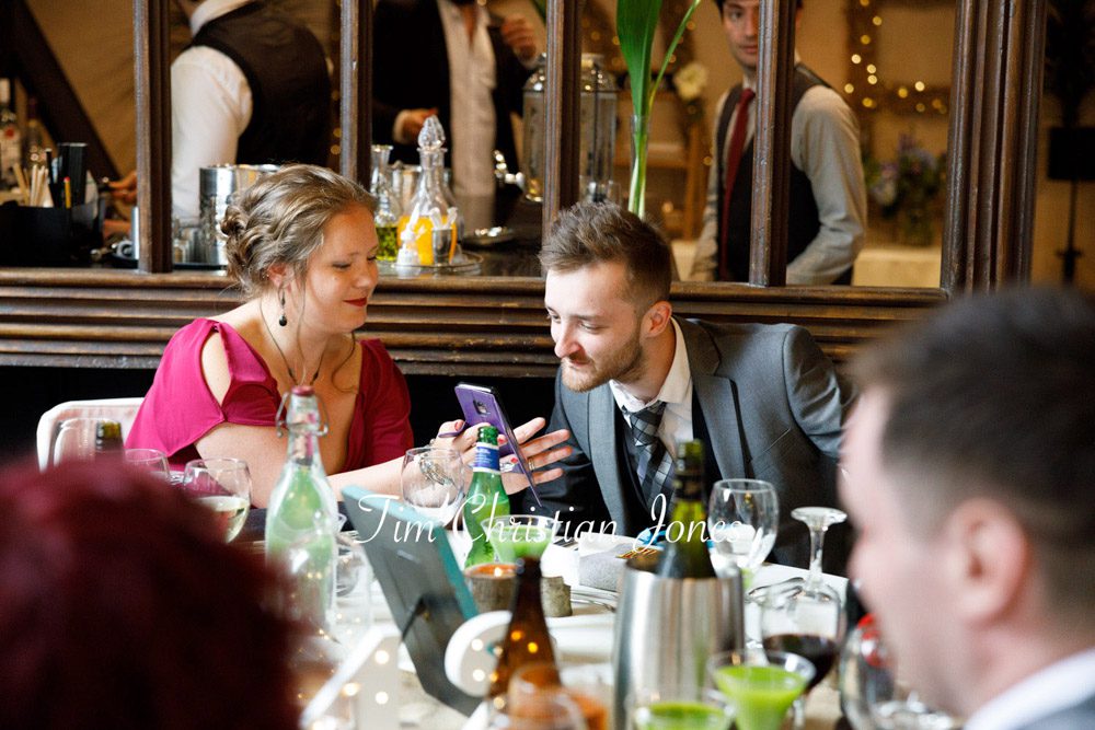 Natural candid moments of guests interacting at Yorkshire wedding.
