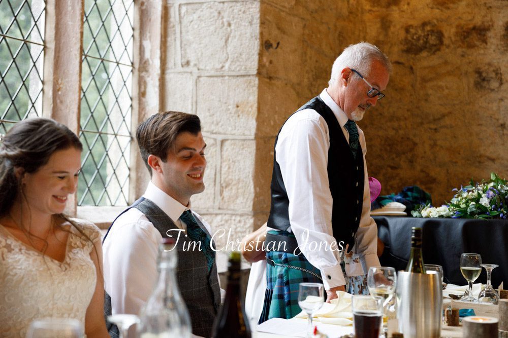 Father of the groom smiling warmly while giving his wedding speech at The Priests House.