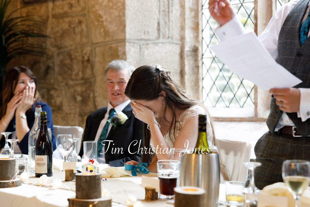 Heartfelt moment as the bride reacts to her husband's wedding toast.