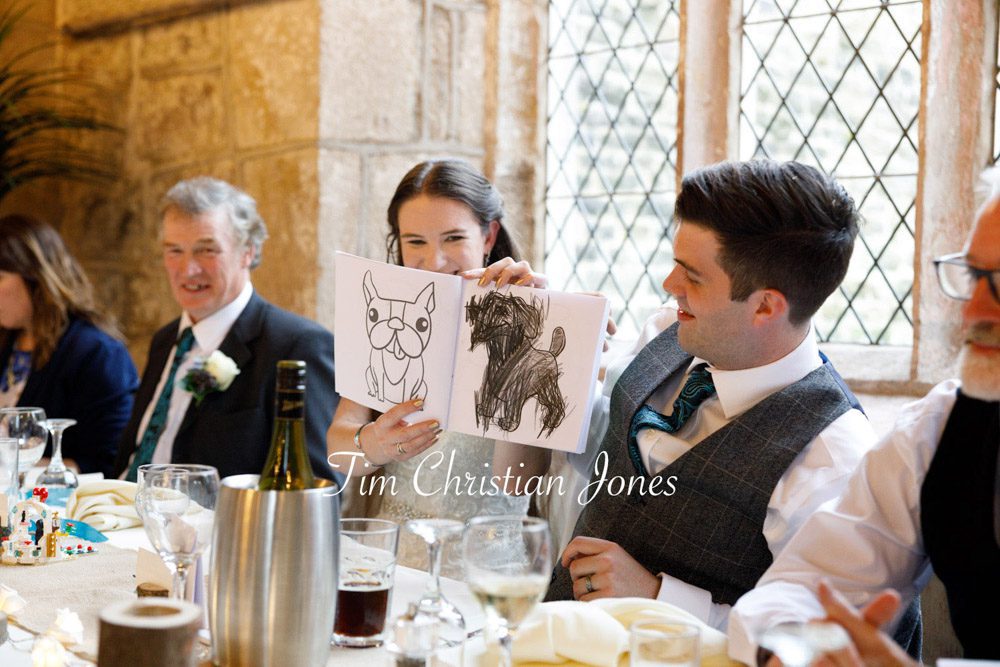 Candid moment as bride shows colouring book to bridesmaids.