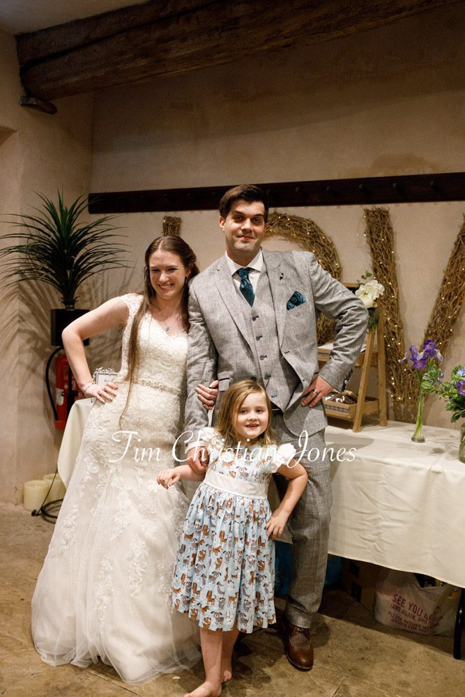 Candid moment of a funny family pose during wedding photos.