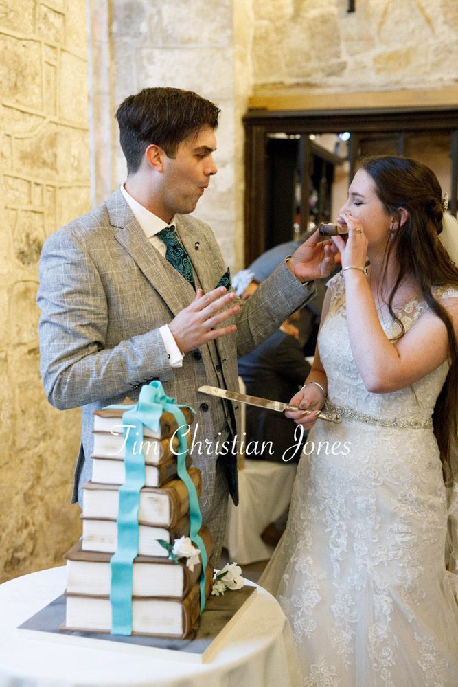 Romantic moment as newlyweds enjoy their first bite of cake.